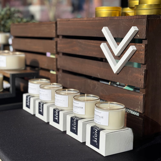 Mini Candles from Footnote Candles. Variety of scents in market display.